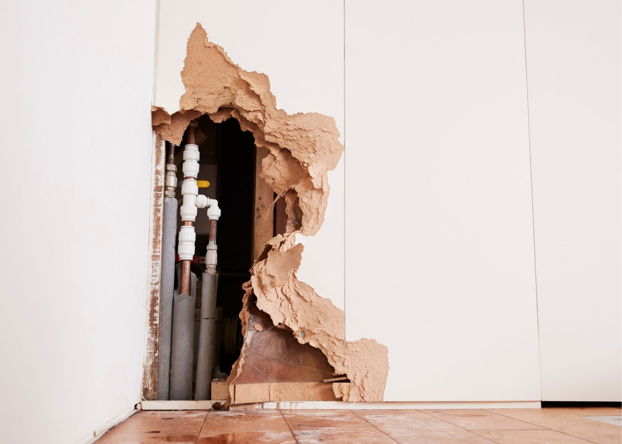 Exposed pipes revealed after leak detection work in an Edgewater, FL home